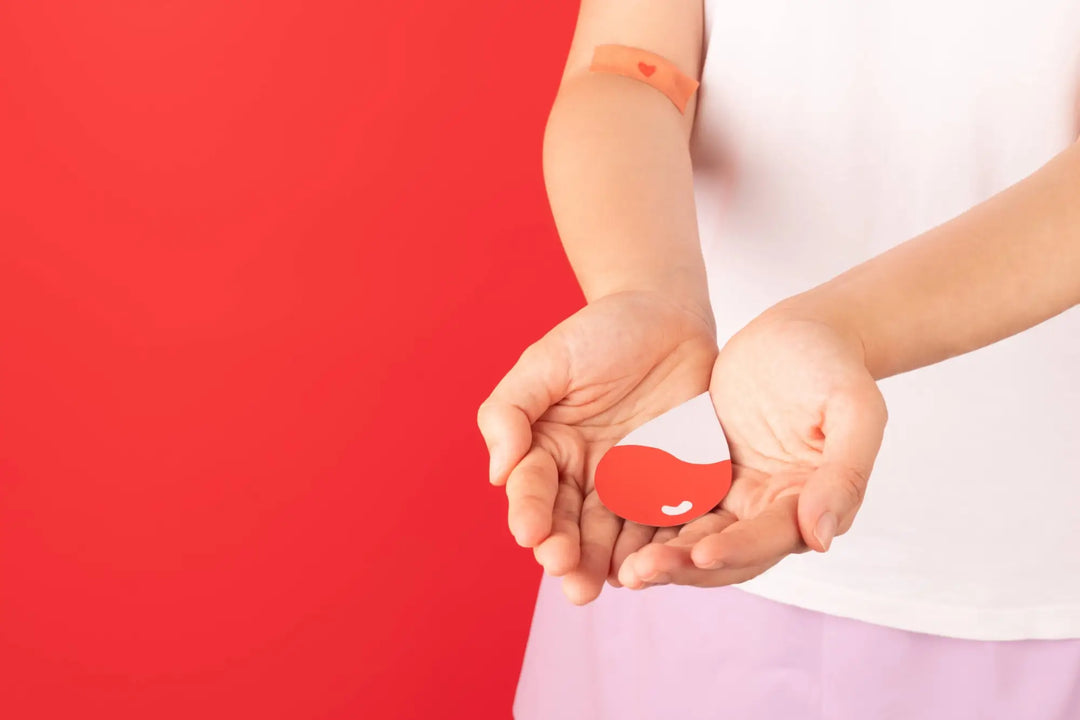 Red and white heart shape in cupped hands symbolizing understanding ITP and herbal goodness.